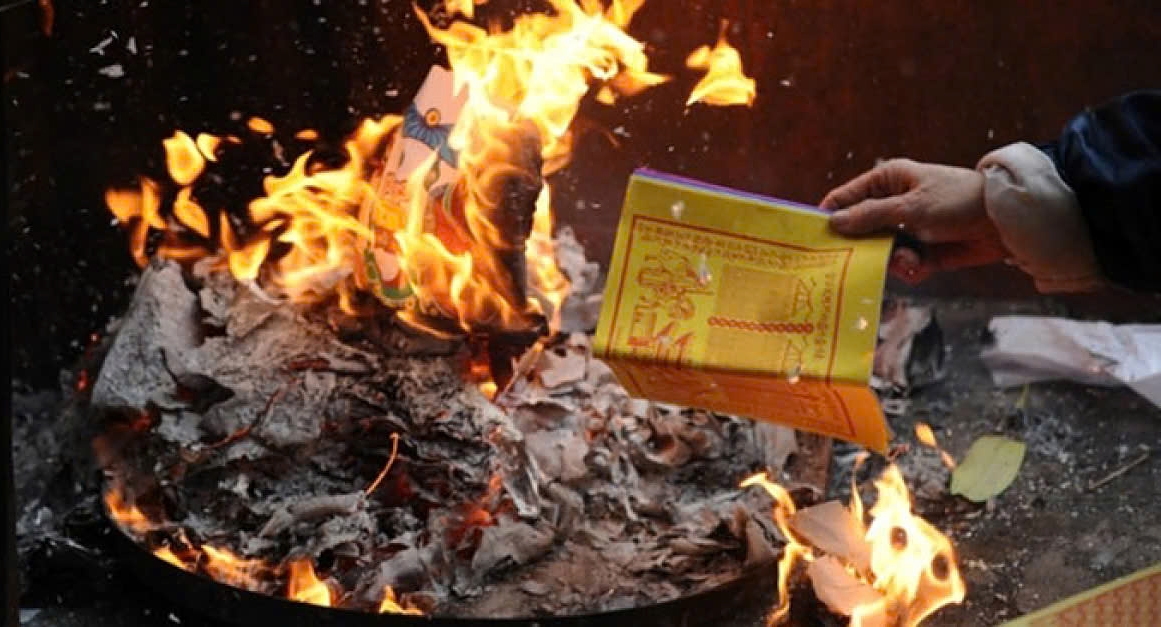 The custom of burning paper offerings during Lunar New Year celebration